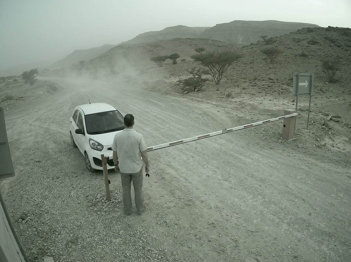 Rental car halted at a barrier on a desert road in Dhofar, Oman (ATC Intel)